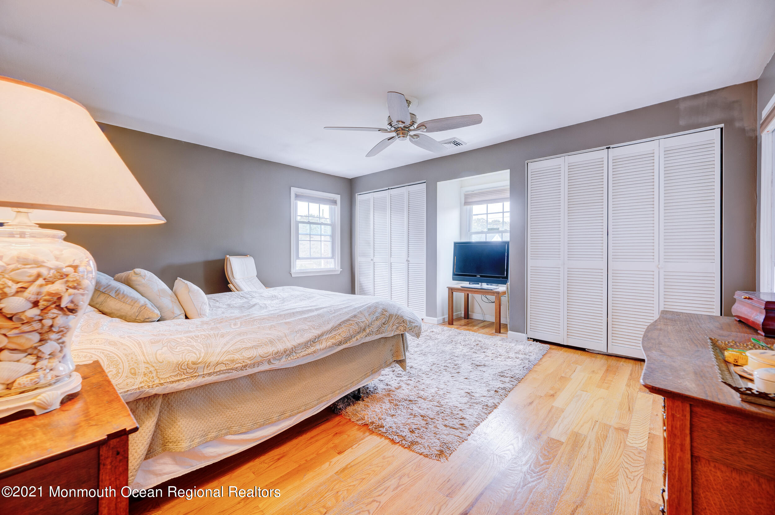 314 Sudbury Road Point Pleasant, NJ 08742 - Photo 15 of 21 a bedroom with a bed and a chandelier