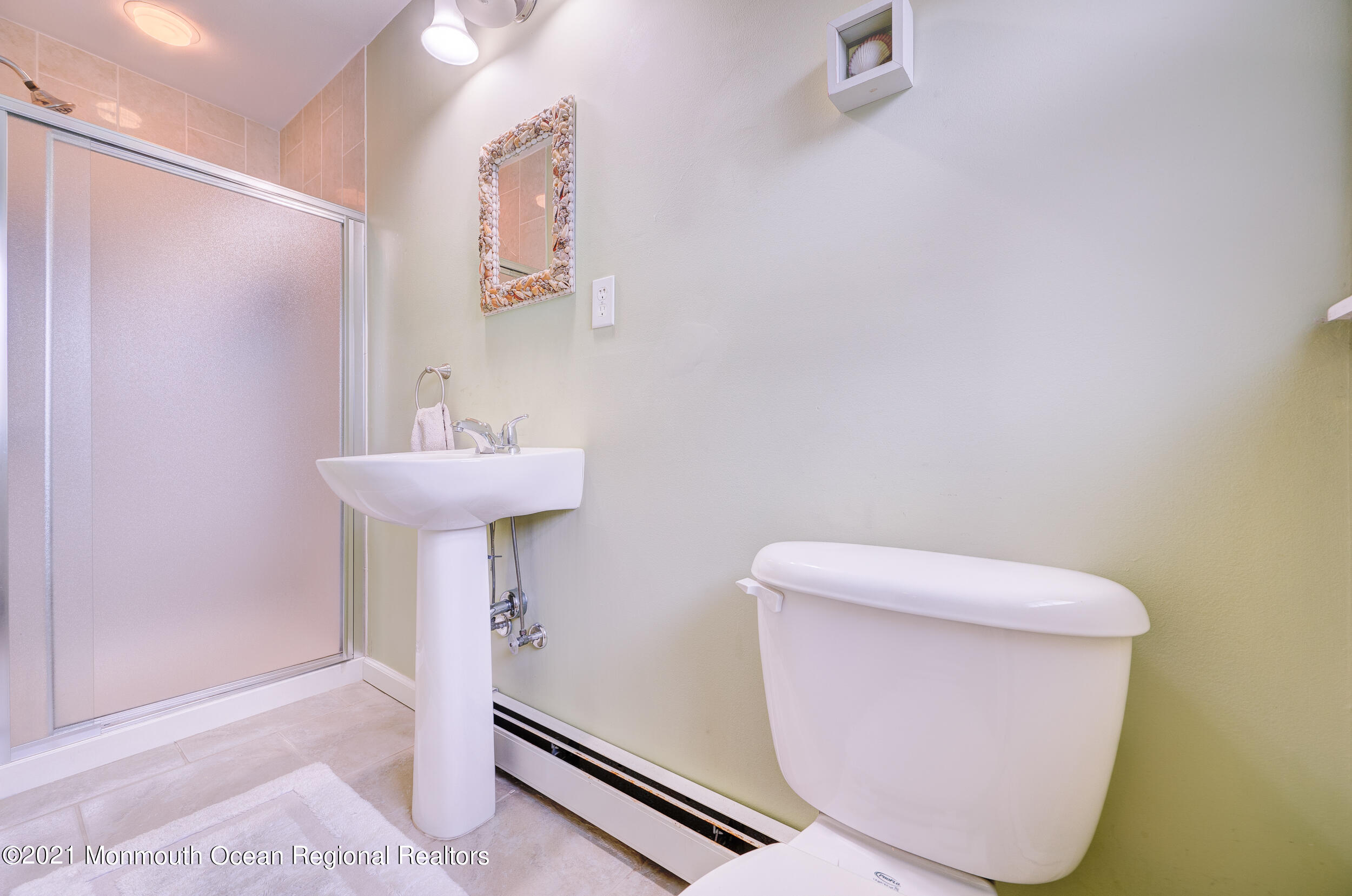 314 Sudbury Road Point Pleasant, NJ 08742 - Photo 18 of 21 a bathroom with a sink toilet and a mirror