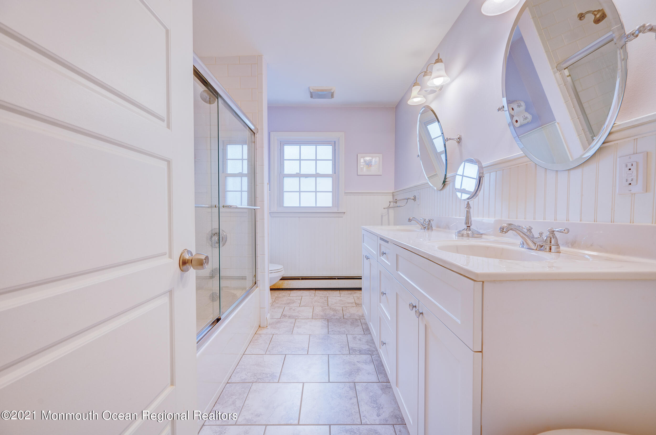 314 Sudbury Road Point Pleasant, NJ 08742 - Photo 19 of 21 a spacious bathroom with a double vanity sink a mirror and a bathtub