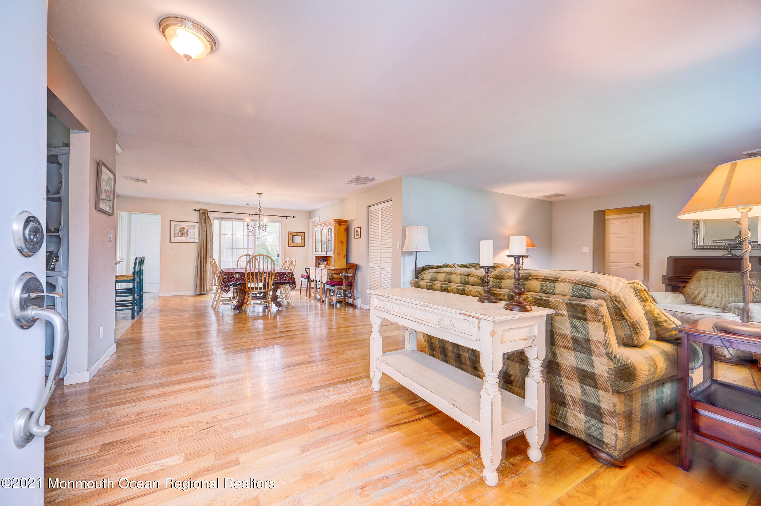 314 Sudbury Road Point Pleasant, NJ 08742 - Photo 5 of 21 a spacious bedroom with a bed a table and a large window