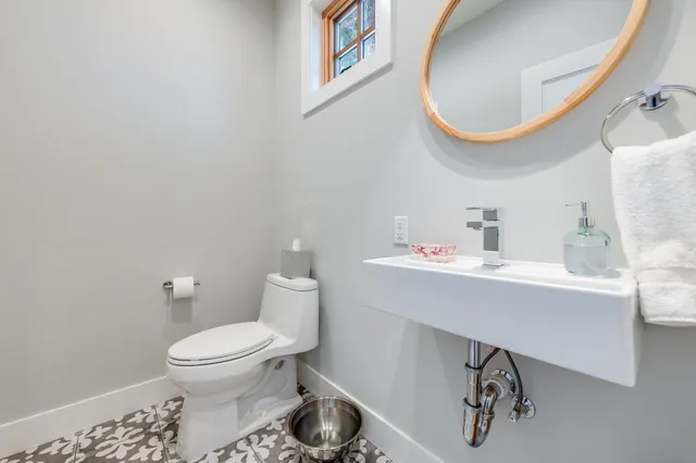 a bathroom with a sink a mirror and a toilet