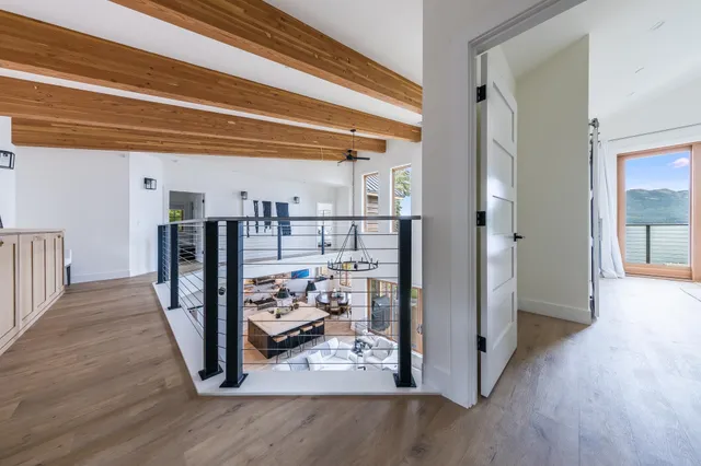 a view of a hallway with wooden floor and entryway