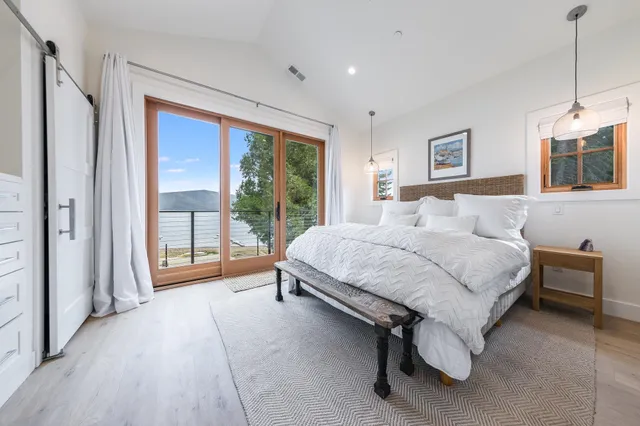 a spacious bedroom with a bed and a large window