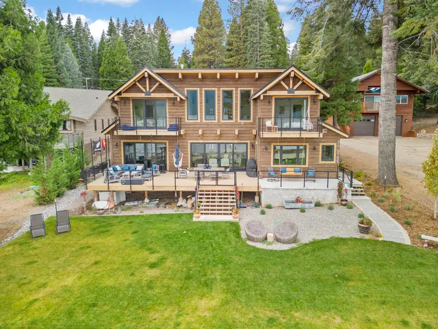 a front view of a house with a garden and swimming pool