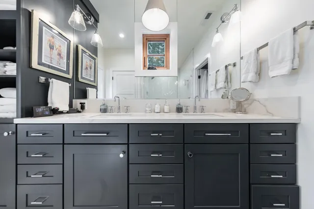 a bathroom with a sink vanity and mirror