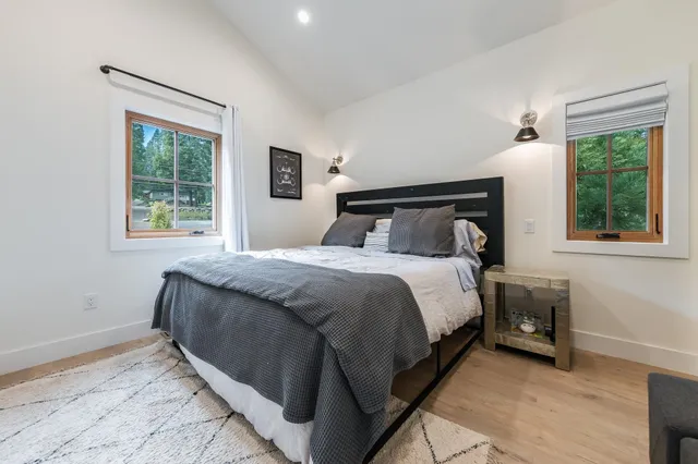 a bed sitting in a bedroom next to a window