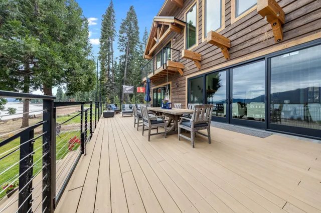 a view of a patio with table and chairs and wooden floor