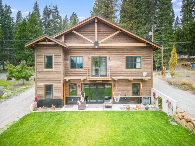 a view of a house with a yard and sitting area