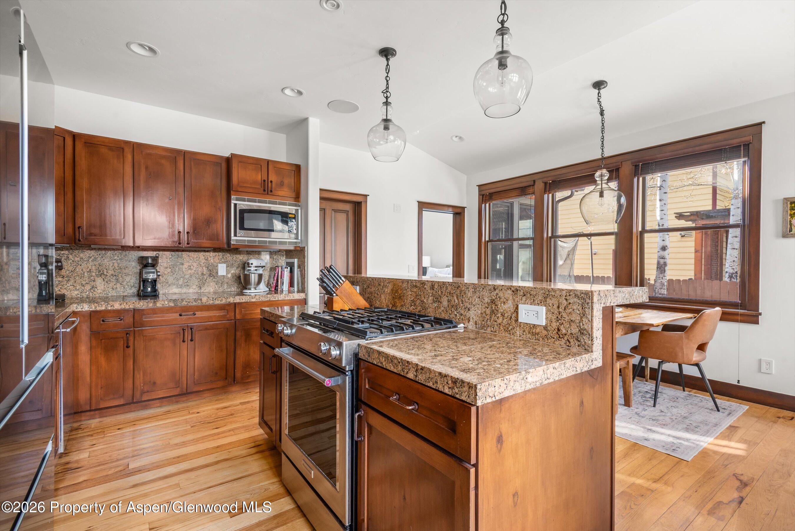 410 Meadow Court Basalt, CO 81621 - Photo 12 of 30 a kitchen with a stove kitchen island and couches