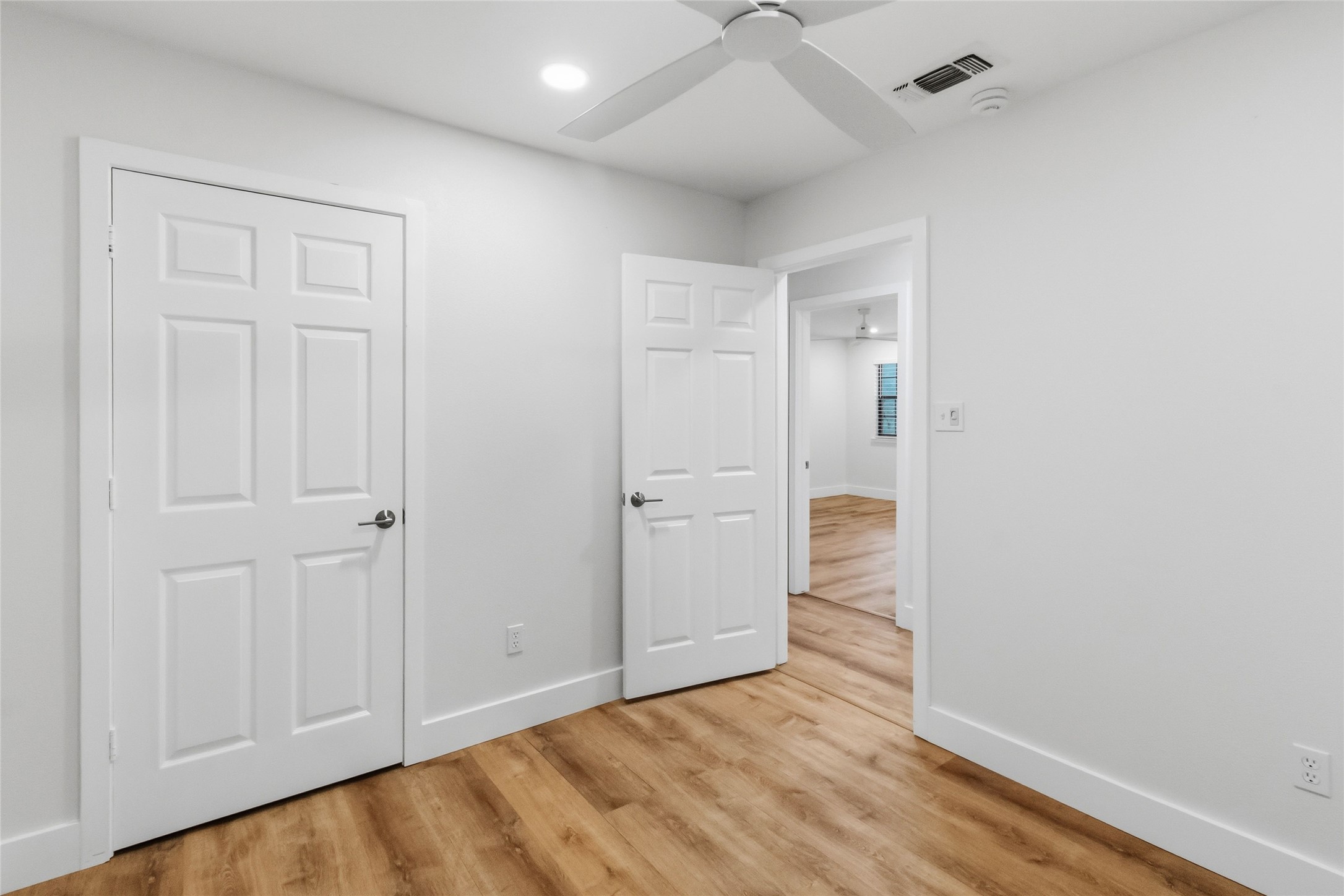 326 Pine View Loop Bastrop, TX 78602 - Photo 16 of 30 Hardwood floors and a ceiling fan create a comfortable atmosphere within this inviting bedroom.