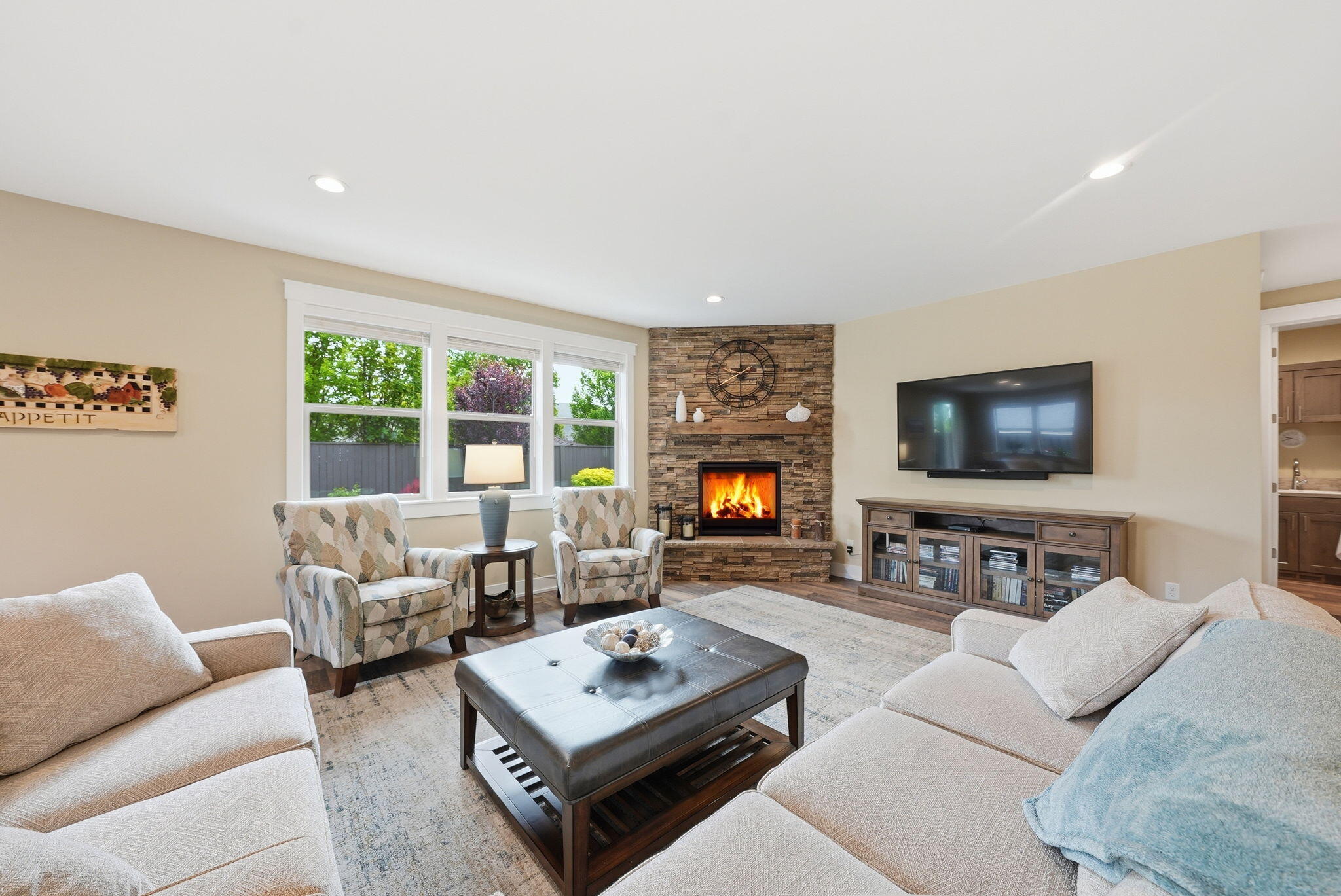 2714 Northwest 23rd Street Redmond, OR 97756 - Photo 5 of 57 a living room with furniture a flat screen tv and a large window