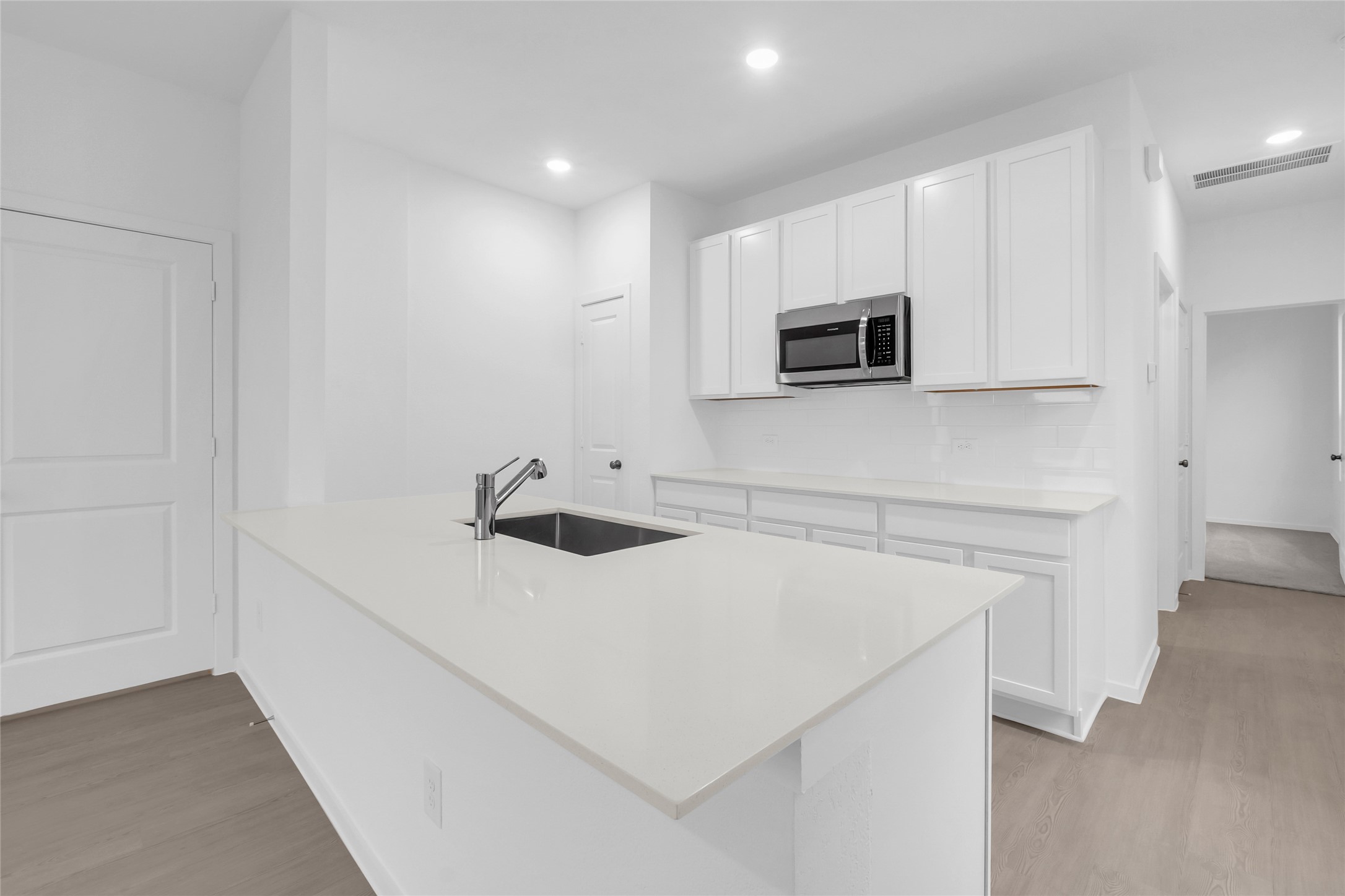 5437 Bear Run Bryan, TX 77807 - Photo 10 of 35 a kitchen with stainless steel appliances a microwave and sink