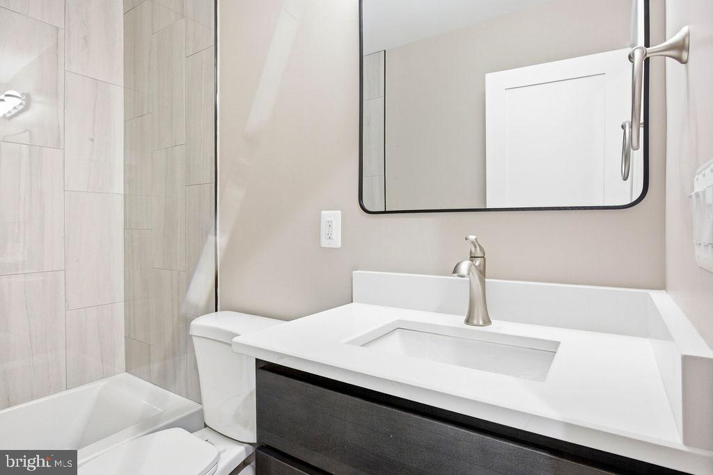 6620 Napoli Road Temple Hills, MD 20748 - Photo 18 of 38 a bathroom with a sink and a mirror