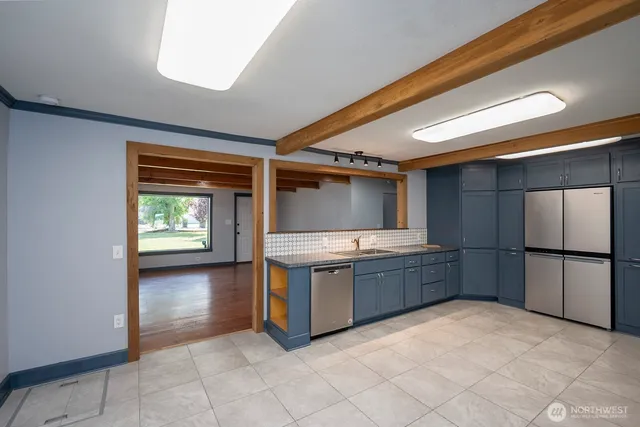 a kitchen with stainless steel appliances granite countertop a refrigerator and a stove top oven