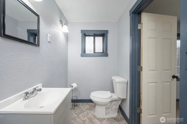 a white toilet sitting next to a bathroom sink