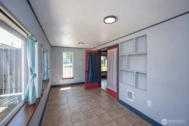 a view of empty room with window and stairs