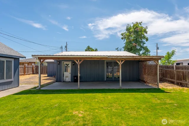 a view of a house with a yard and furniture