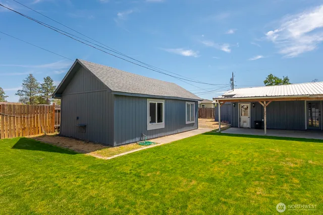 a view of a house with a yard and a tub