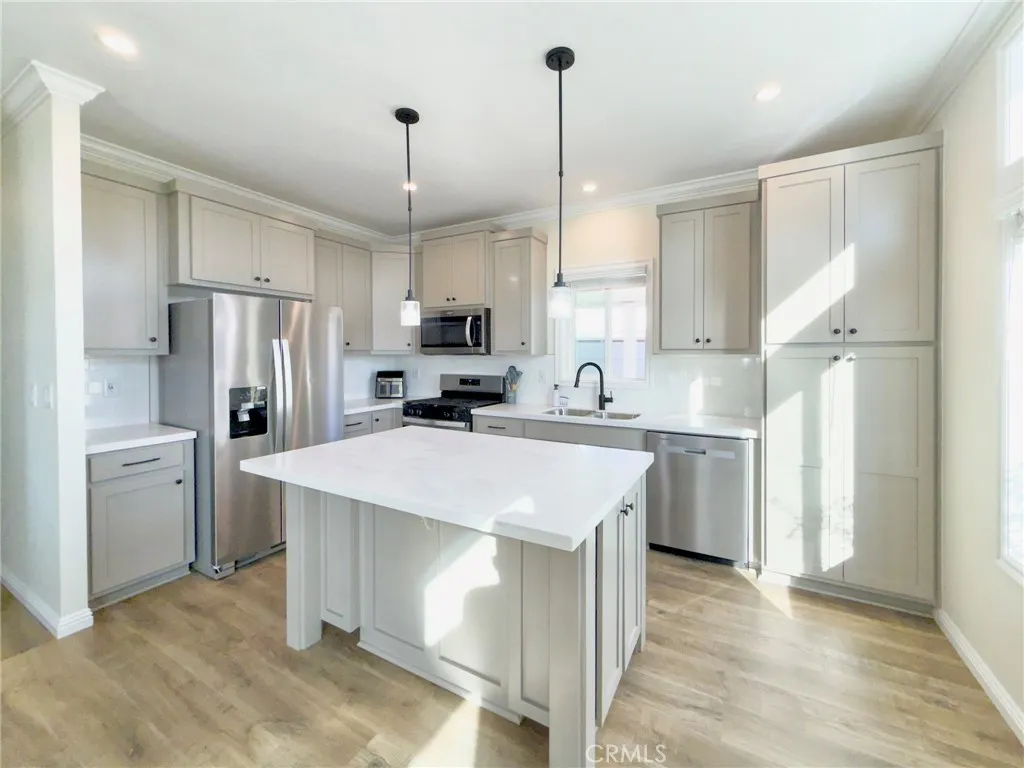 12530 Royal, Unit 46 El Cajon, CA 92021 - Photo 2 of 17 a kitchen with a sink a center island stainless steel appliances and cabinets