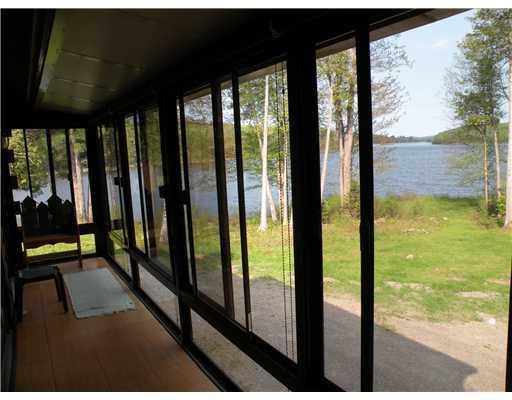 91 Ostrom Road Bowerbank, ME 04426 - Photo 17 of 25 Patio/Deck. Screened-in porch on the...