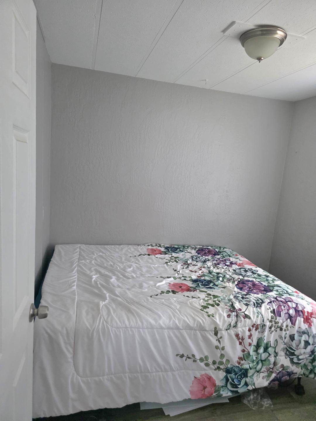 264 Mercury Circle Gustine, CA 95322 - Photo 11 of 18 a bedroom with a bed and a wooden floor