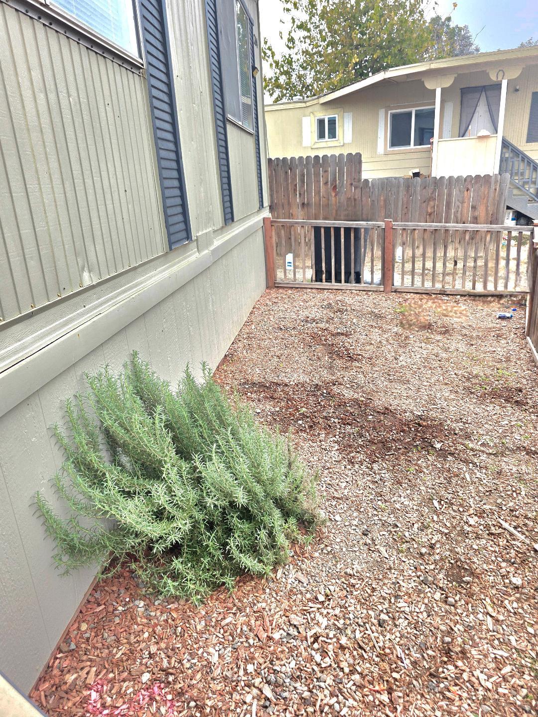264 Mercury Circle Gustine, CA 95322 - Photo 3 of 18 a view of backyard with a garden and deck