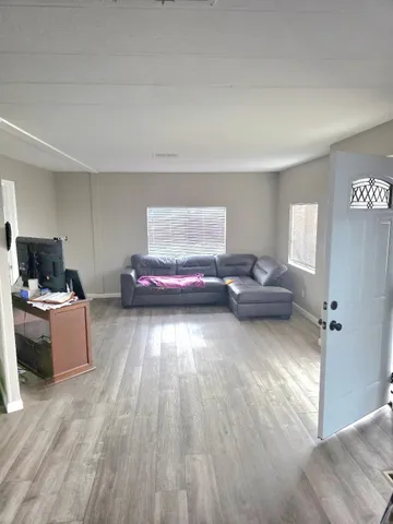 a view of a workspace with wooden floor and a chair