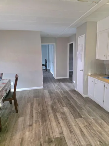 a kitchen with kitchen island a counter top space a sink stainless steel appliances and cabinets