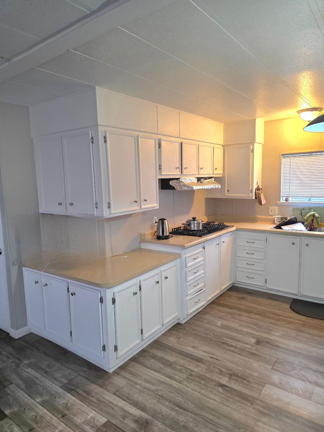 264 Mercury Circle Gustine, CA 95322 - Photo 7 of 18 a kitchen with granite countertop white cabinets and white appliances