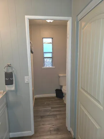 a bedroom with a bed and a wooden floor