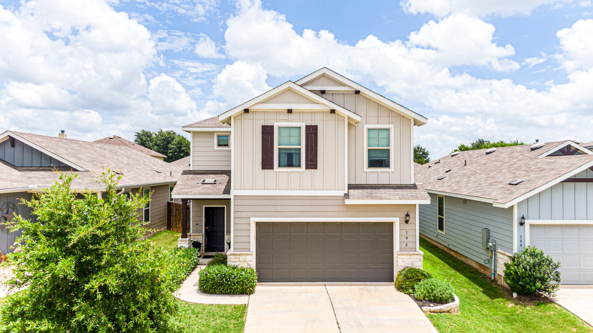 192 Spotted Rail Ridge Leander, TX 78641 - Photo 2 of 34 a front view of a house with a garden