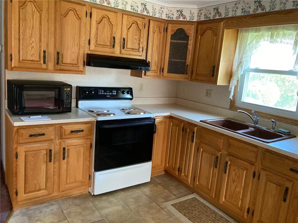 325 Owen Drive Johnstown, PA 15904 - Photo 5 of 15 a kitchen with stainless steel appliances granite countertop a stove a sink and a microwave