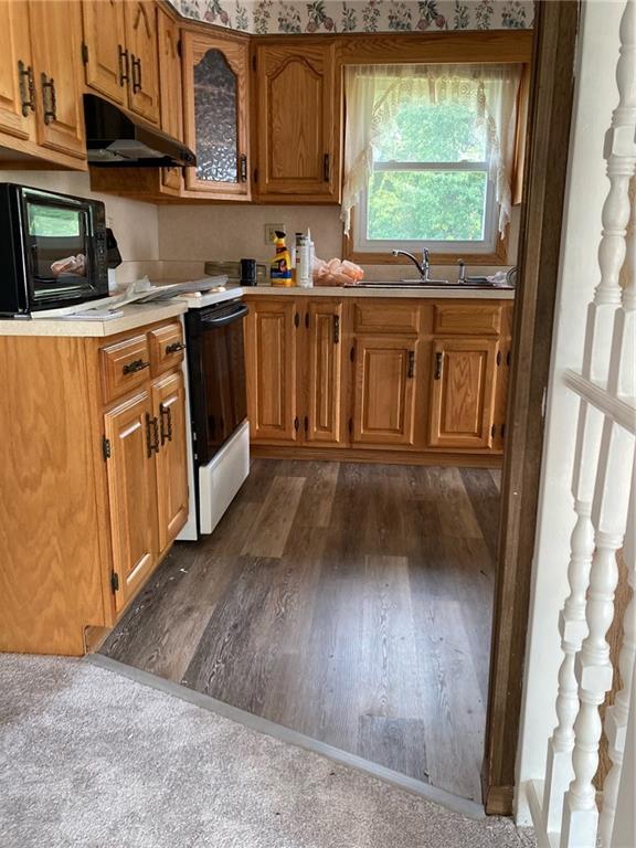 325 Owen Drive Johnstown, PA 15904 - Photo 6 of 15 a kitchen with stainless steel appliances granite countertop a stove a sink and a refrigerator with wooden floors