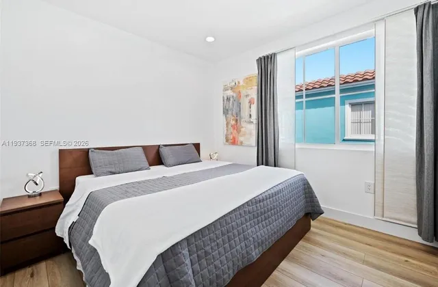 a bedroom with a bed and window