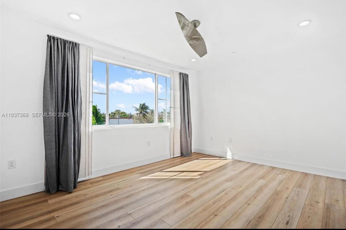 1705 Johnson Street, Unit B Hollywood, FL 33020 - Photo 16 of 34 wooden floor in an empty room with a window