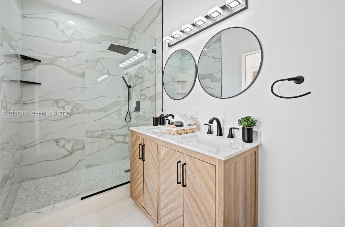 1705 Johnson Street, Unit B Hollywood, FL 33020 - Photo 18 of 34 a bathroom with a sink and a mirror