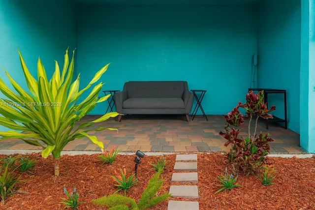 a backyard of a house with table and chairs