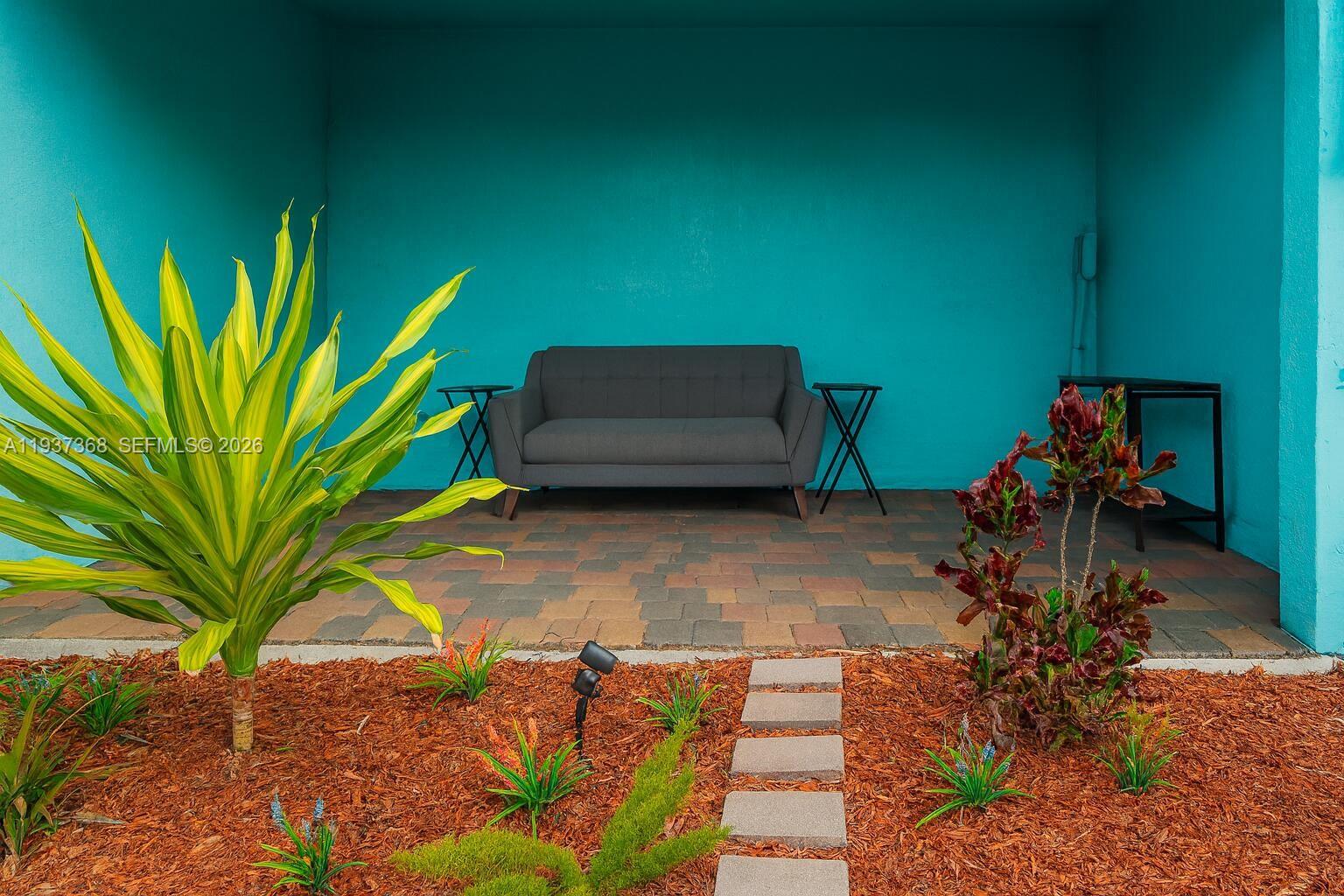 1705 Johnson Street, Unit B Hollywood, FL 33020 - Photo 21 of 34 a backyard of a house with table and chairs