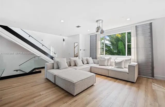 a living room with furniture and a large window