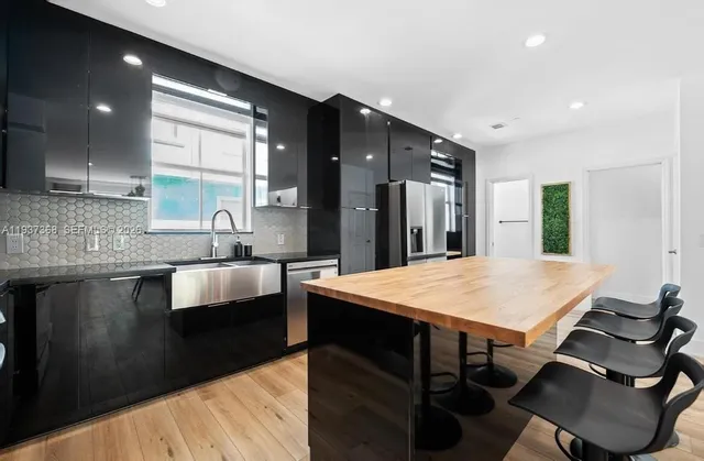 a kitchen with kitchen island a sink table and chairs