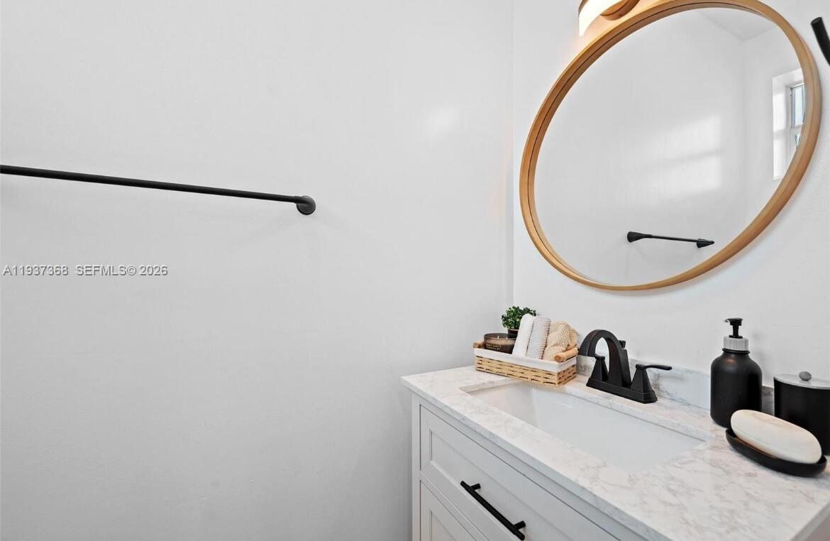 1705 Johnson Street, Unit B Hollywood, FL 33020 - Photo 10 of 34 a bathroom with a sink and a mirror