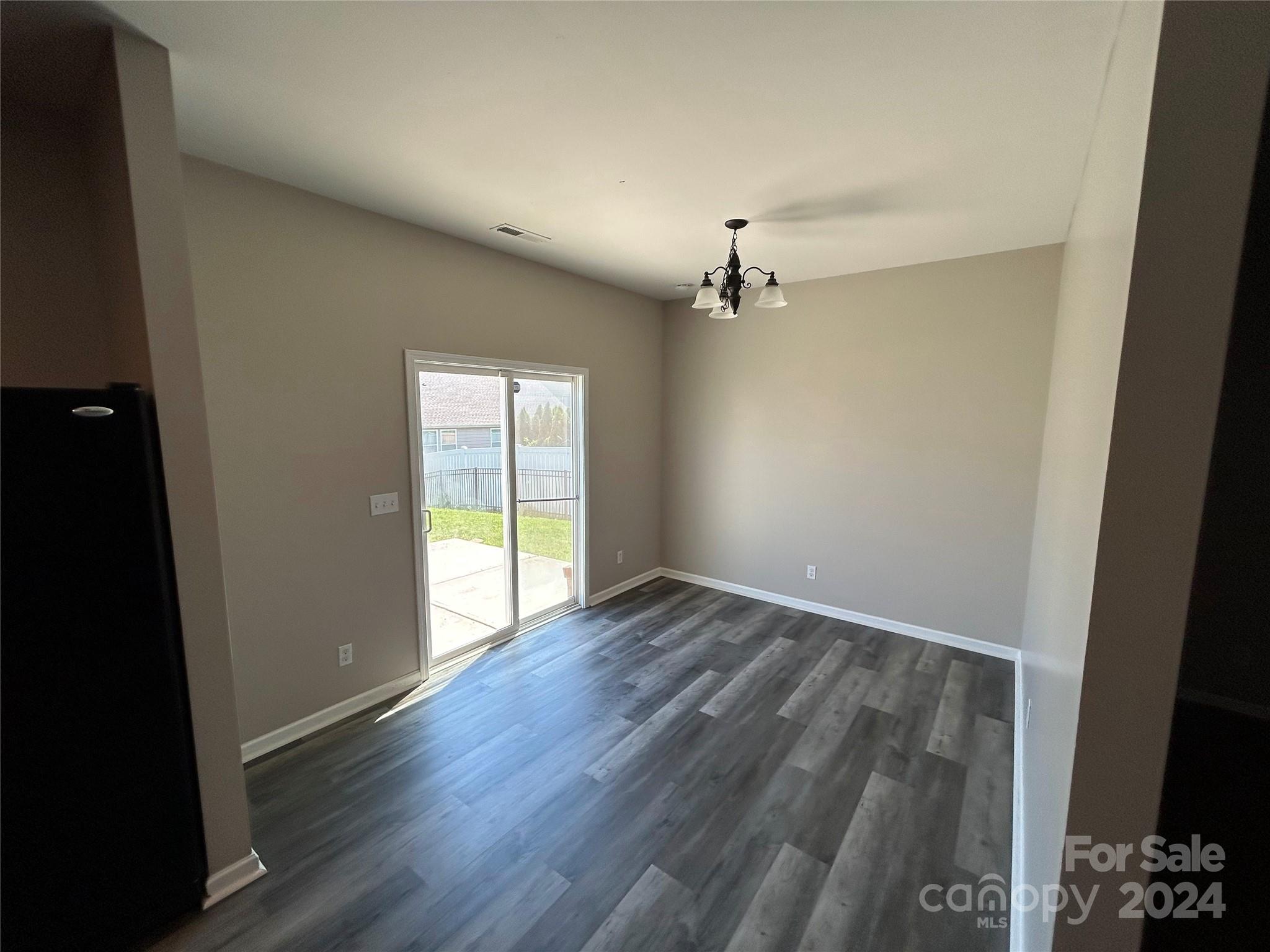 1012 Green Terra Road Indian Trail, NC 28079 - Photo 4 of 14 an empty room with wooden floor and windows