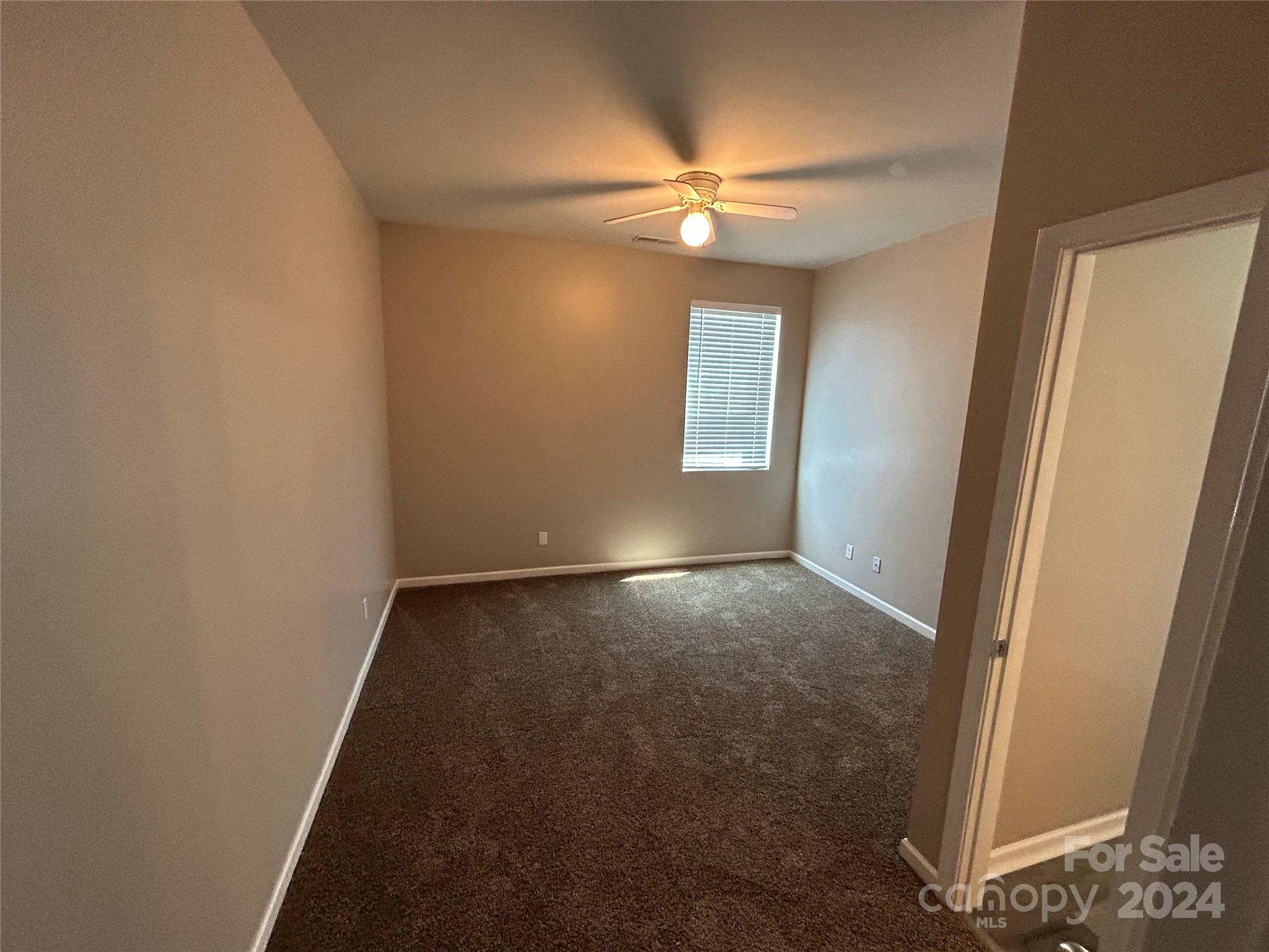 1012 Green Terra Road Indian Trail, NC 28079 - Photo 7 of 14 an empty room with windows and fan