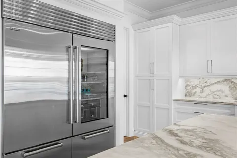 a bathroom with a granite countertop sink a toilet and shower