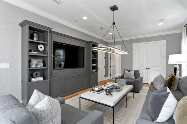 a living room with furniture a window and a chandelier