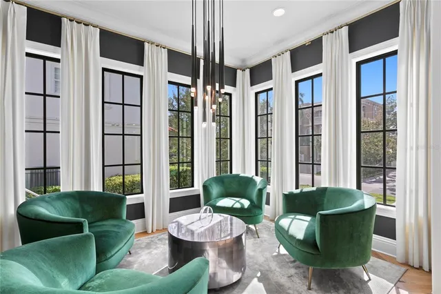 a living room with furniture kitchen and a large window