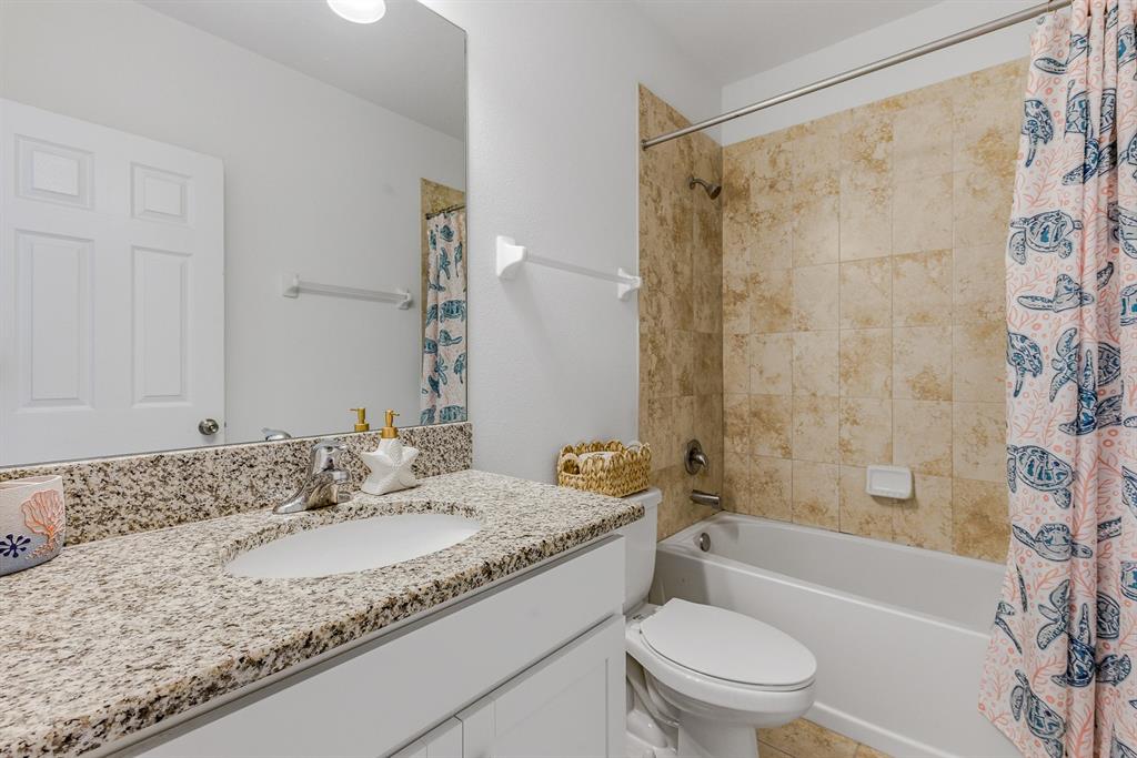 12218 Gothic Rd Spring Hill Spring Hill, FL 34610 - Photo 17 of 56 a bathroom with a granite countertop sink a toilet and shower