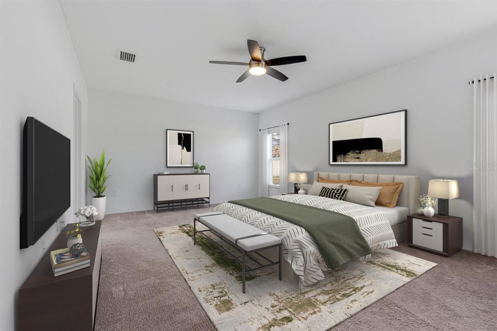 12218 Gothic Rd Spring Hill Spring Hill, FL 34610 - Photo 21 of 56 a spacious bedroom with a bed and a flat screen tv