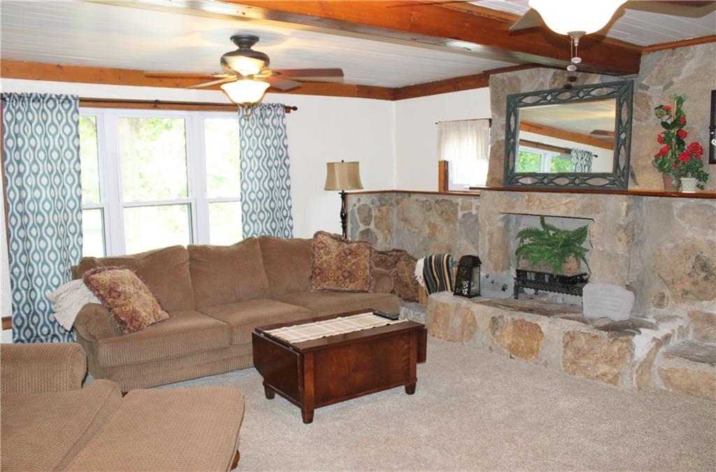 The original stone wall provides a rustic home for the electric fireplace...
