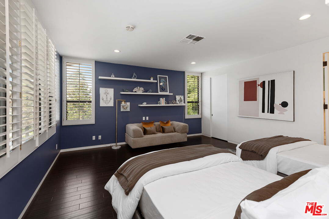 1018 Summit Drive Beverly Hills, CA 90210 - Photo 14 of 21 a bedroom with two beds and a large window